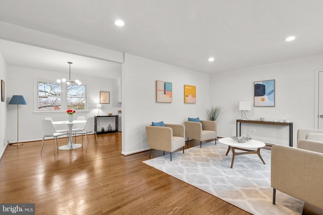 living room with a chandelier, baseboards, wood finished floors, and recessed lighting