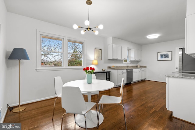 dining space featuring baseboards, dark wood finished floors, and a notable chandelier