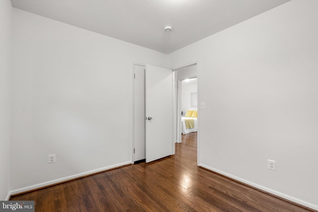 unfurnished room featuring wood finished floors and baseboards