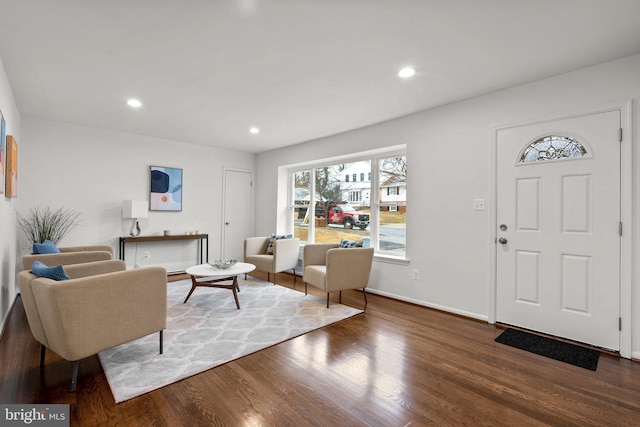 living area featuring baseboards, dark wood-style flooring, and recessed lighting