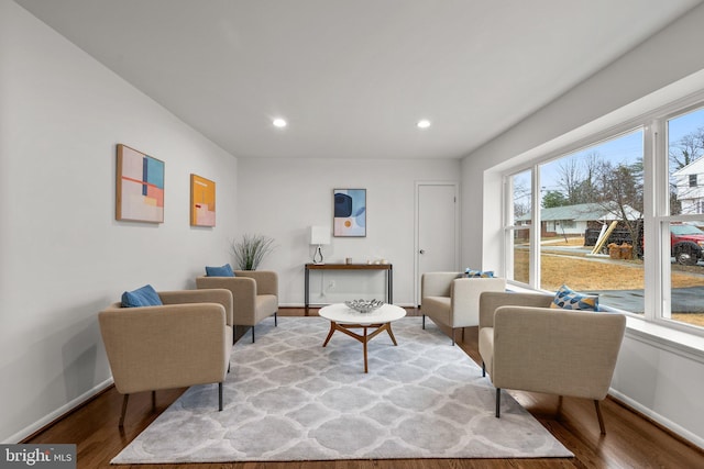 living room with recessed lighting, baseboards, and wood finished floors