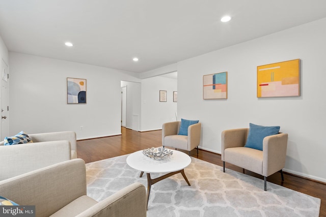 living area with recessed lighting, baseboards, and wood finished floors