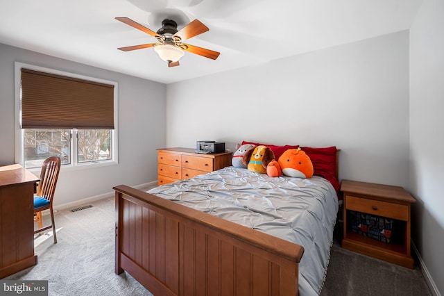 bedroom featuring visible vents, light colored carpet, a ceiling fan, and baseboards