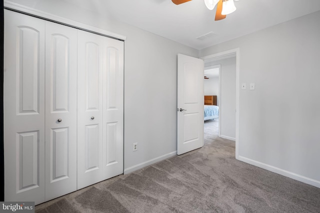 unfurnished bedroom featuring a closet, baseboards, visible vents, and carpet floors