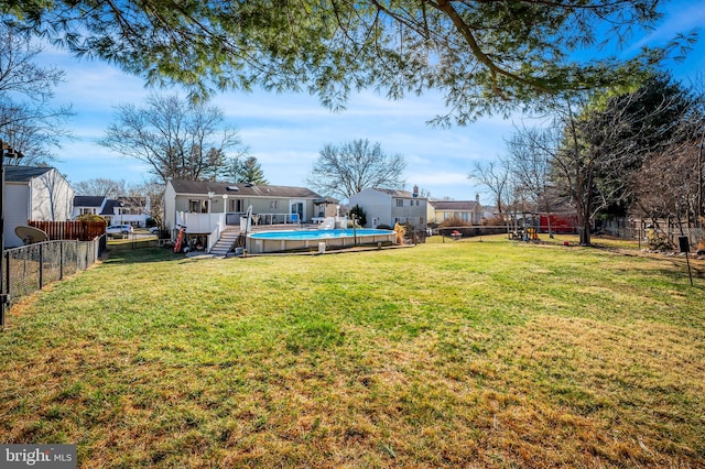 view of yard featuring a playground, a fenced in pool, and a fenced backyard