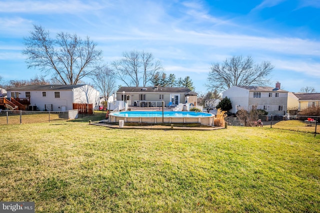 exterior space with a residential view, a lawn, a fenced backyard, and a fenced in pool