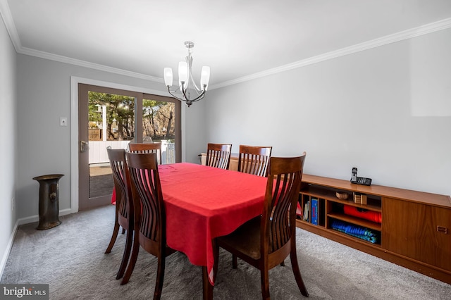 carpeted dining room with baseboards, an inviting chandelier, and crown molding