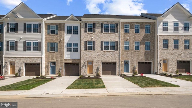 view of property with driveway and brick siding