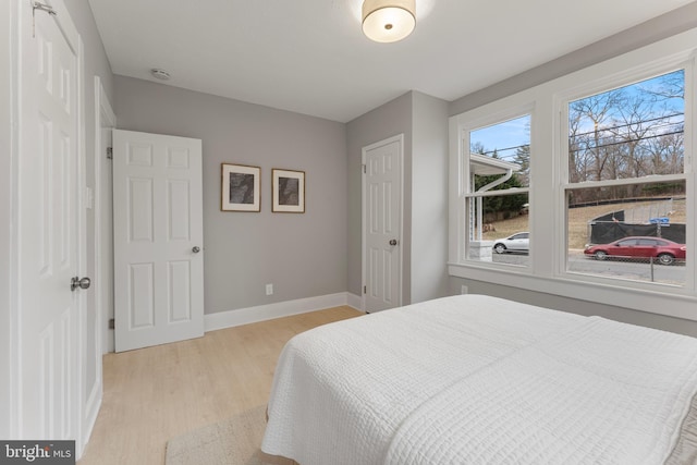 bedroom featuring baseboards and light wood-style floors