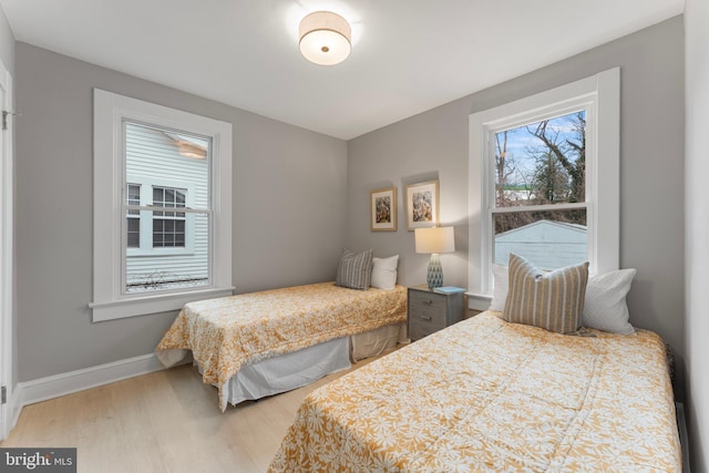 bedroom featuring wood finished floors and baseboards