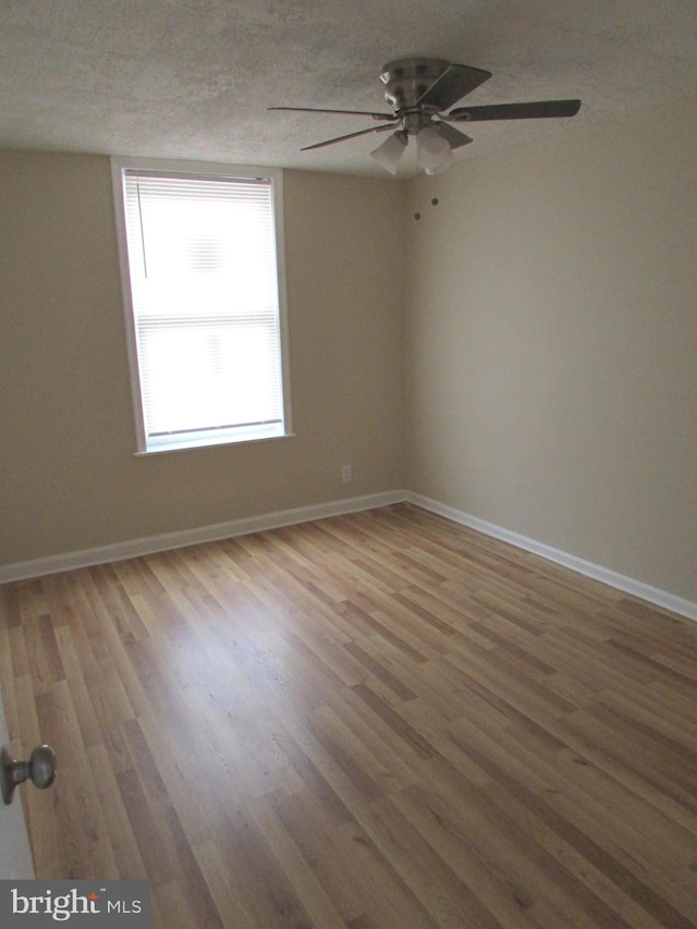 unfurnished room featuring wood finished floors and baseboards