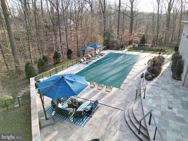 view of pool with a fenced in pool, a patio, and fence