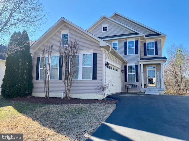 view of front of house with a garage and aphalt driveway