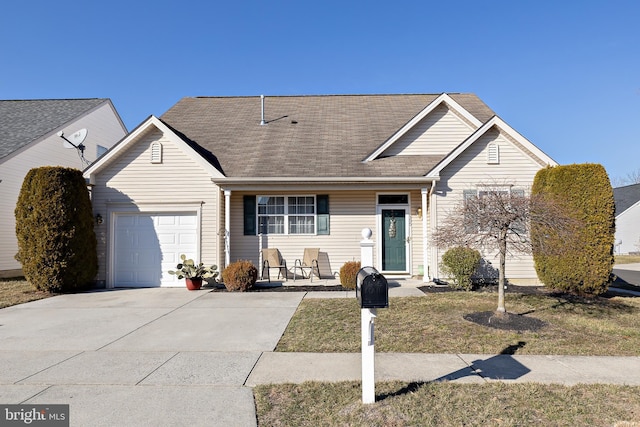 view of front facade with a garage, roof with shingles, and driveway