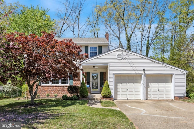 traditional-style home with brick siding, a garage, a front yard, a chimney, and driveway
