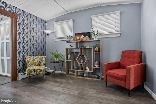 living area with lofted ceiling, wood finished floors, and baseboards