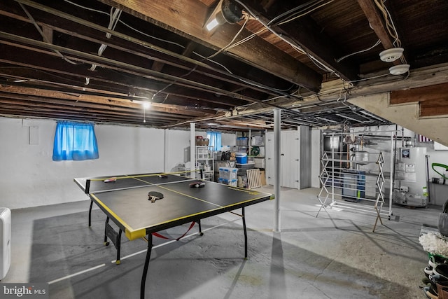 rec room featuring water heater and concrete floors