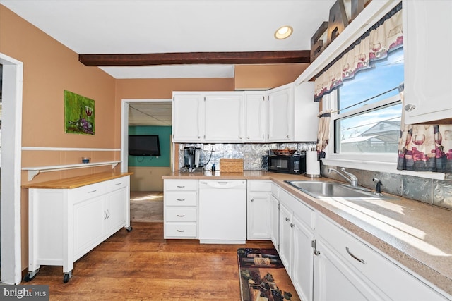 kitchen with dishwasher, white cabinetry, and a sink