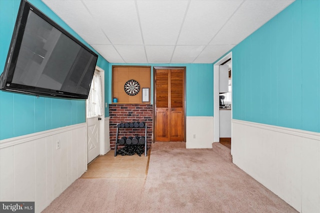 interior space featuring a drop ceiling and carpet floors