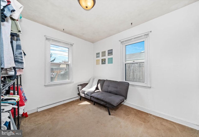 living area with baseboards, baseboard heating, and carpet floors