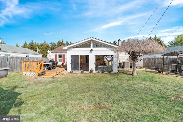 back of property with cooling unit, a deck, a lawn, and a fenced backyard