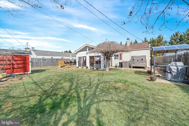 view of yard with an outdoor structure and a fenced backyard