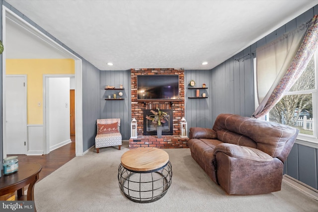 carpeted living area featuring recessed lighting and a fireplace