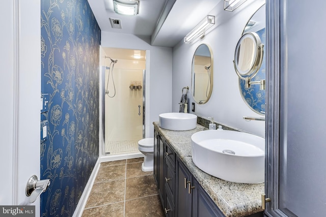 bathroom with visible vents, a stall shower, a sink, tile patterned flooring, and baseboards