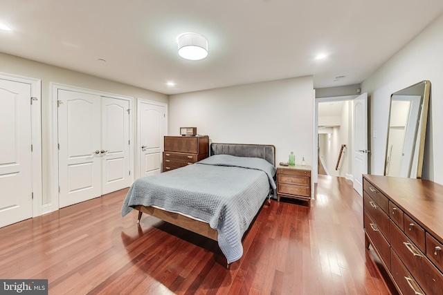 bedroom featuring wood finished floors and recessed lighting