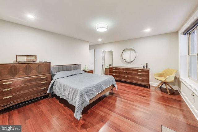 bedroom featuring recessed lighting, wood finished floors, and baseboards