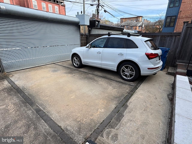 view of parking / parking lot with fence