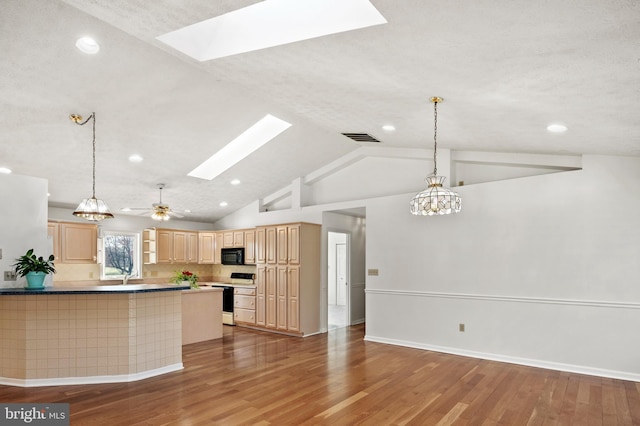 kitchen featuring visible vents, black microwave, light brown cabinetry, range with electric stovetop, and wood finished floors