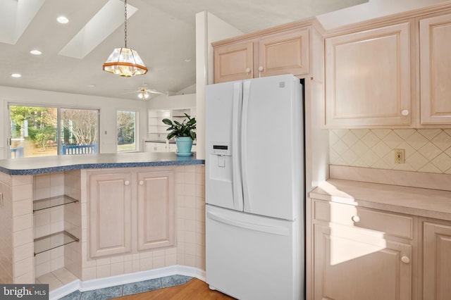 kitchen featuring tasteful backsplash, light brown cabinets, recessed lighting, white refrigerator with ice dispenser, and hanging light fixtures