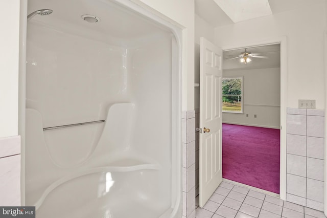 bathroom with walk in shower, ceiling fan, and tile patterned flooring