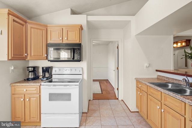 kitchen featuring black microwave, vaulted ceiling, white electric range oven, light tile patterned flooring, and a sink