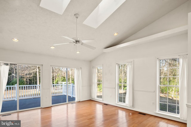 interior space with recessed lighting, visible vents, lofted ceiling with skylight, and hardwood / wood-style flooring