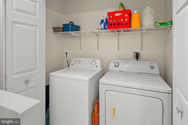 clothes washing area featuring independent washer and dryer and laundry area