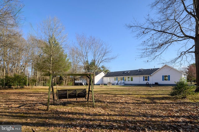 exterior space with a carport and a lawn