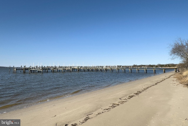 view of dock with a view of the beach and a water view