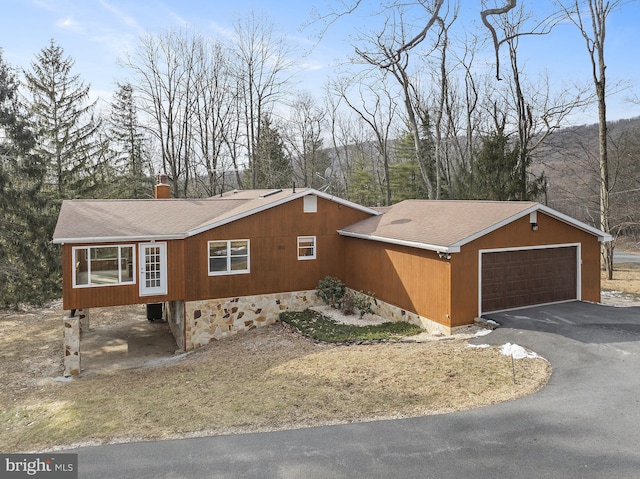 view of property exterior with a shingled roof, crawl space, a chimney, and an attached garage