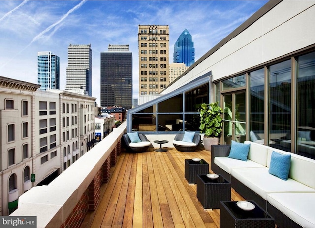 wooden deck featuring a view of city and outdoor lounge area