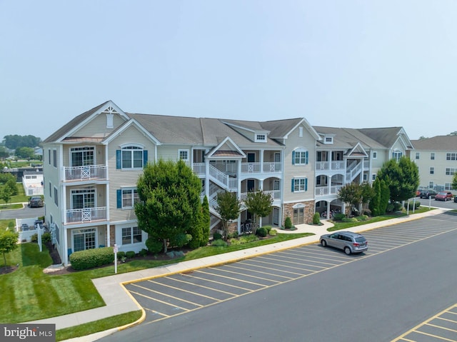 view of building exterior featuring uncovered parking