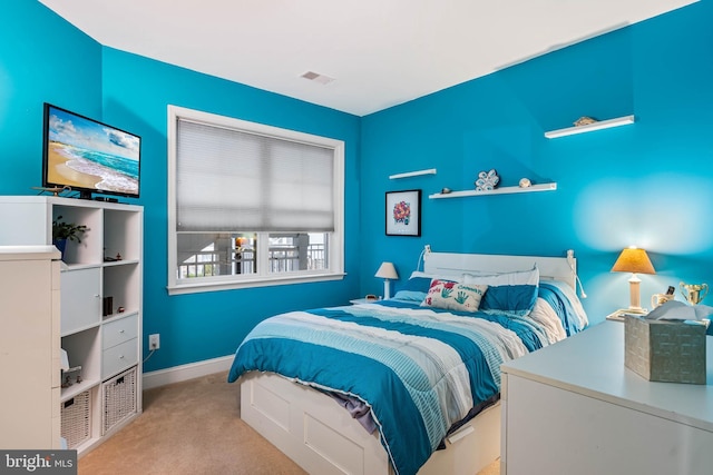 carpeted bedroom featuring baseboards and visible vents