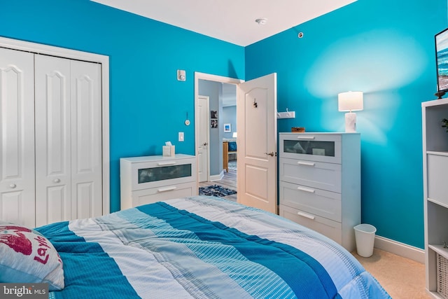 bedroom featuring a closet, carpet floors, and baseboards