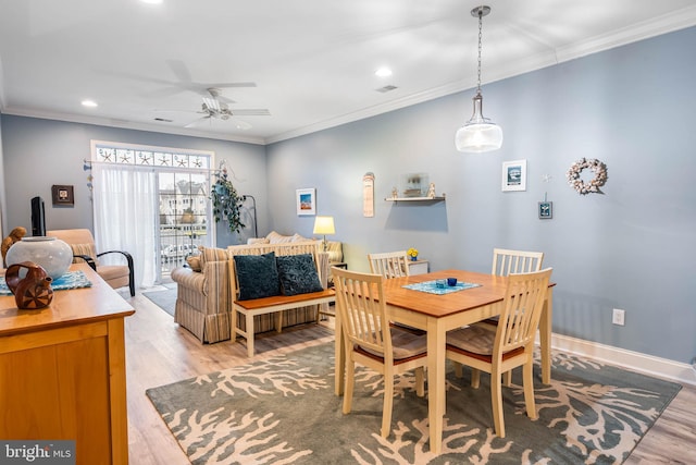 dining room with ceiling fan, baseboards, light wood-style floors, and ornamental molding