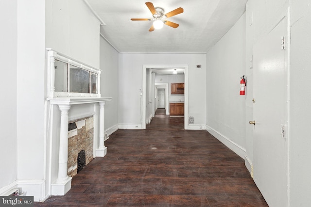 hall featuring baseboards and wood finished floors