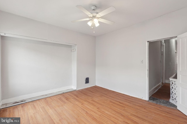 empty room featuring visible vents, ceiling fan, and light wood-style flooring