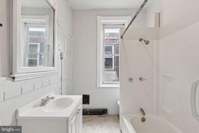 bathroom featuring tile patterned flooring, bathtub / shower combination, and vanity