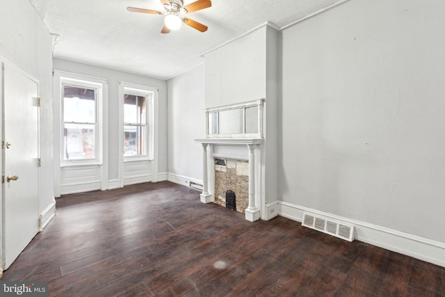 unfurnished living room with visible vents, a fireplace, hardwood / wood-style floors, and ceiling fan