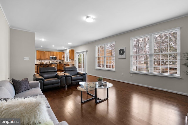 living area with recessed lighting, dark wood finished floors, visible vents, and baseboards